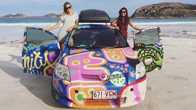 Asia Wilmot and a friend standing next to a car